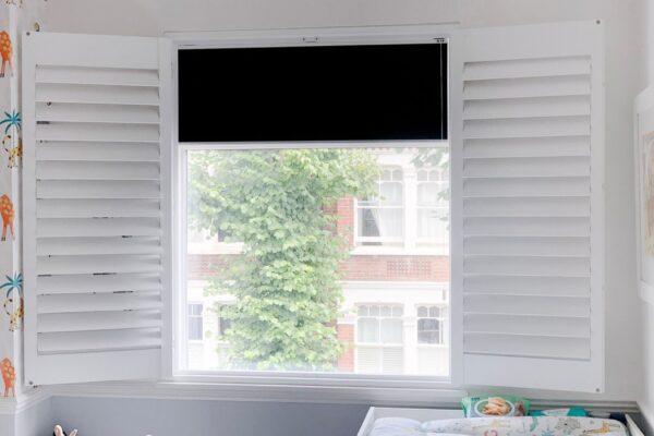 Blackout roller blind behind shutters