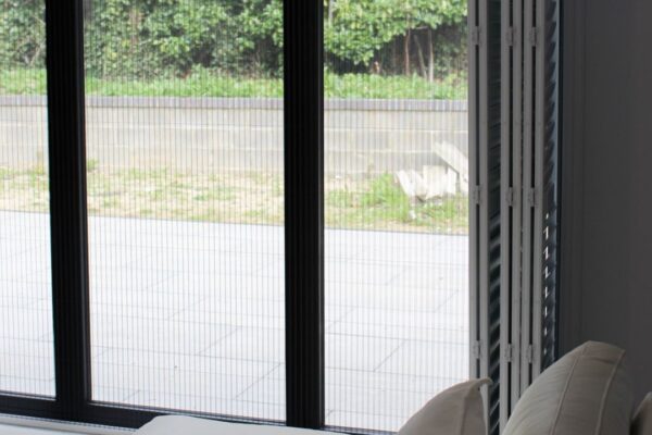 Fly screen installed behind shutter doors